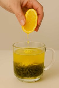 Squeezing fresh lemon into a glass mug of brazilian mounjaro recipe