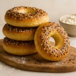 Freshly baked cottage cheese bagels on wooden board