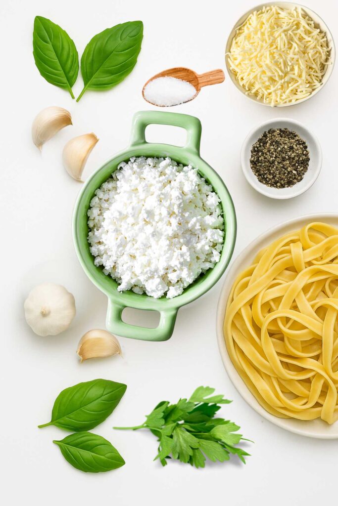 Ingredients for cottage cheese pasta sauce on white background