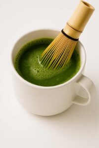 Whisking matcha in a mug for natural mounjaro recipe